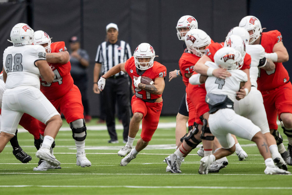 UNLV running back Spencer Briggs (21) rushes threw an open gap during the first half of a scrim ...
