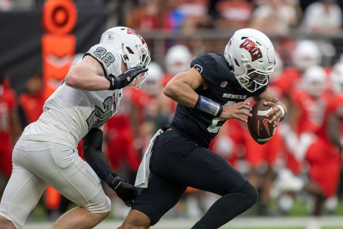 UNLV quarterback Doug Brumfield (2) is forced out of the pocket by linebacker Fisher Carmac (28 ...