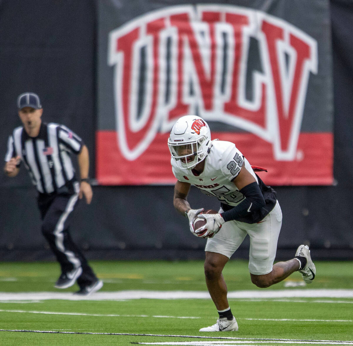 UNLV defensive back Jordyn Morgan (25) runs back an interception during the first half of a scr ...