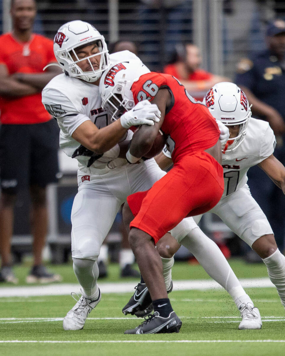 UNLV linebacker Ryan Tuaolo (45) brings down running back Courtney Reese (26) during the second ...