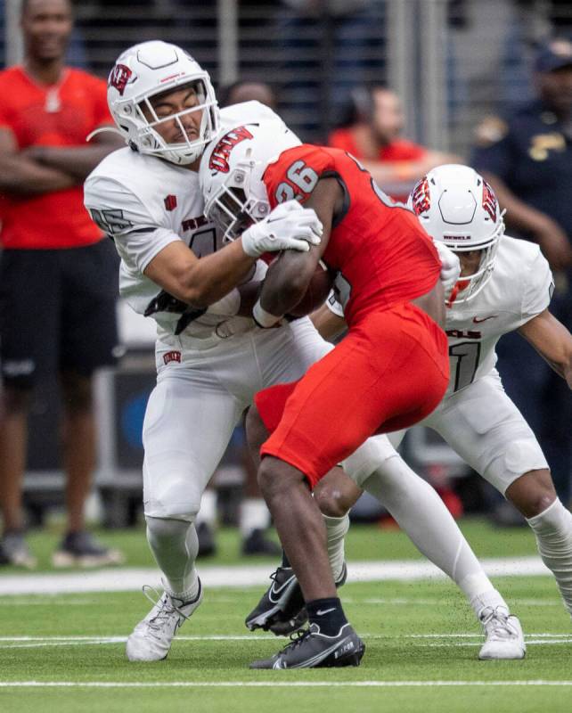 UNLV linebacker Ryan Tuaolo (45) brings down running back Courtney Reese (26) during the second ...