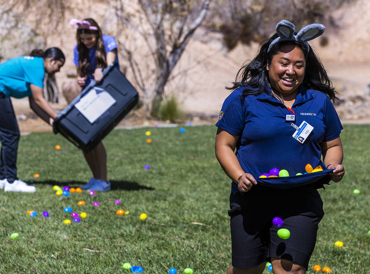 Recreation coordinator Emeline Hernandez runs with and drops eggs strategically about a field f ...