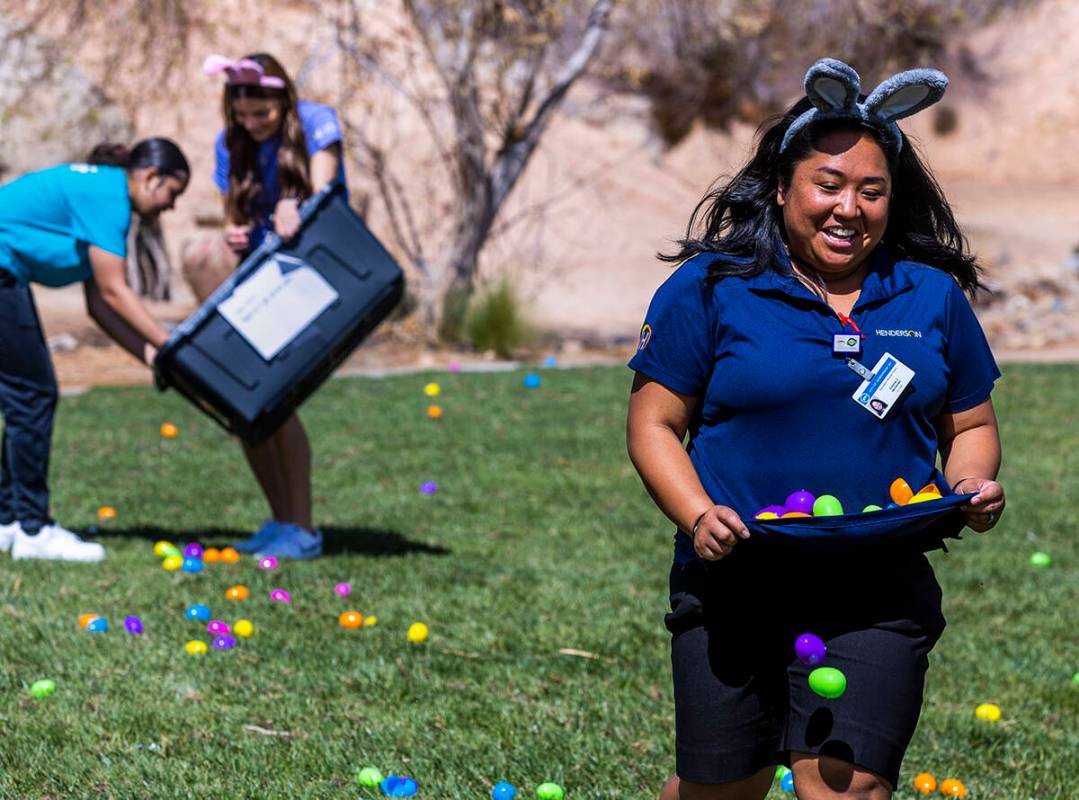 Recreation coordinator Emeline Hernandez runs with and drops eggs strategically about a field f ...