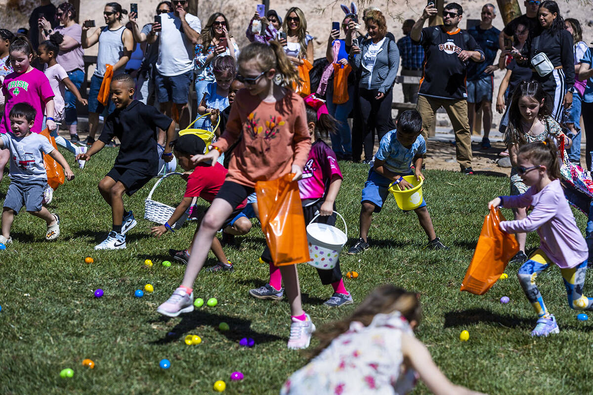 Children ages 4-7 take to the field to gather up the eggs during the annual Spring Carnival at ...