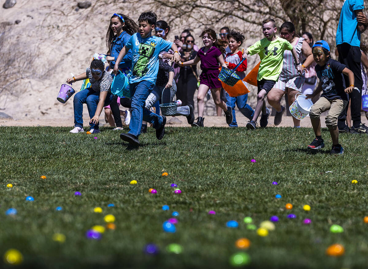 Children ages 8-10 run onto the field for their egg hunt during the annual Spring Carnival at t ...