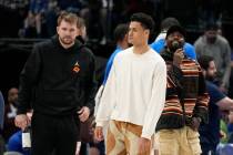 Dallas Mavericks' Luka Doncic, left, Josh Green, center, and Kyrie Irving, right, stand on the ...