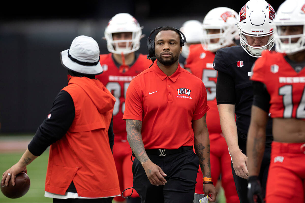 Offensive coordinator Brennan Marion coaches from the sidelines during the UNLV spring showcase ...