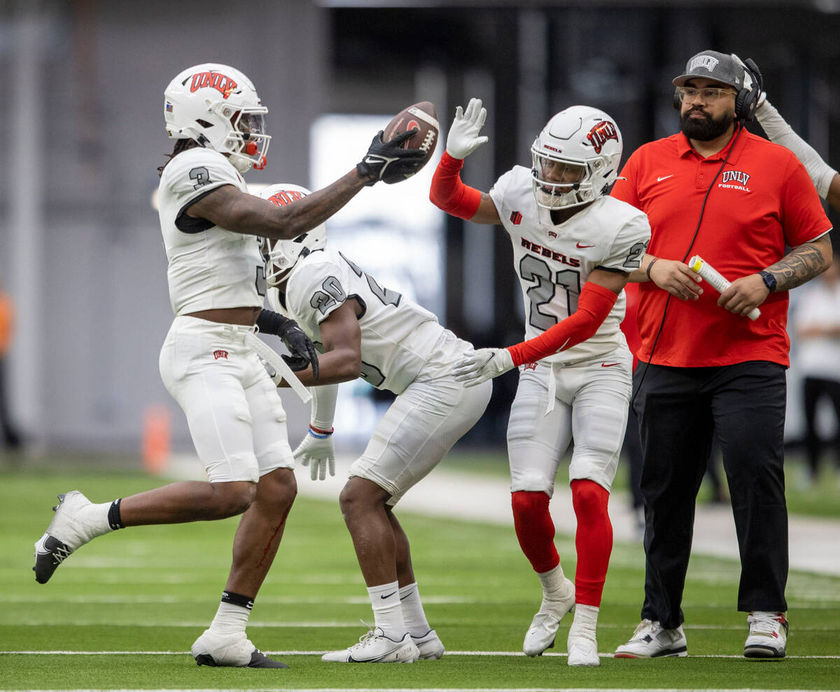 UNLV defensive back Johnathan Baldwin (3) celebrates his interception with BJ Harris (21) durin ...