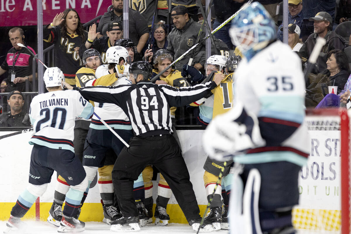 Golden Knights players fight with the Seattle Kraken during the first period of an NHL hockey g ...