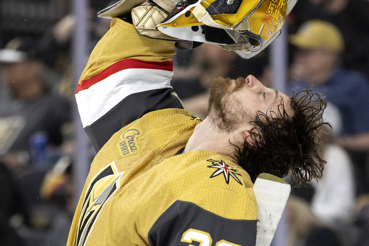 Golden Knights goaltender Laurent Brossoit (39) shakes his hair out during the second period of ...