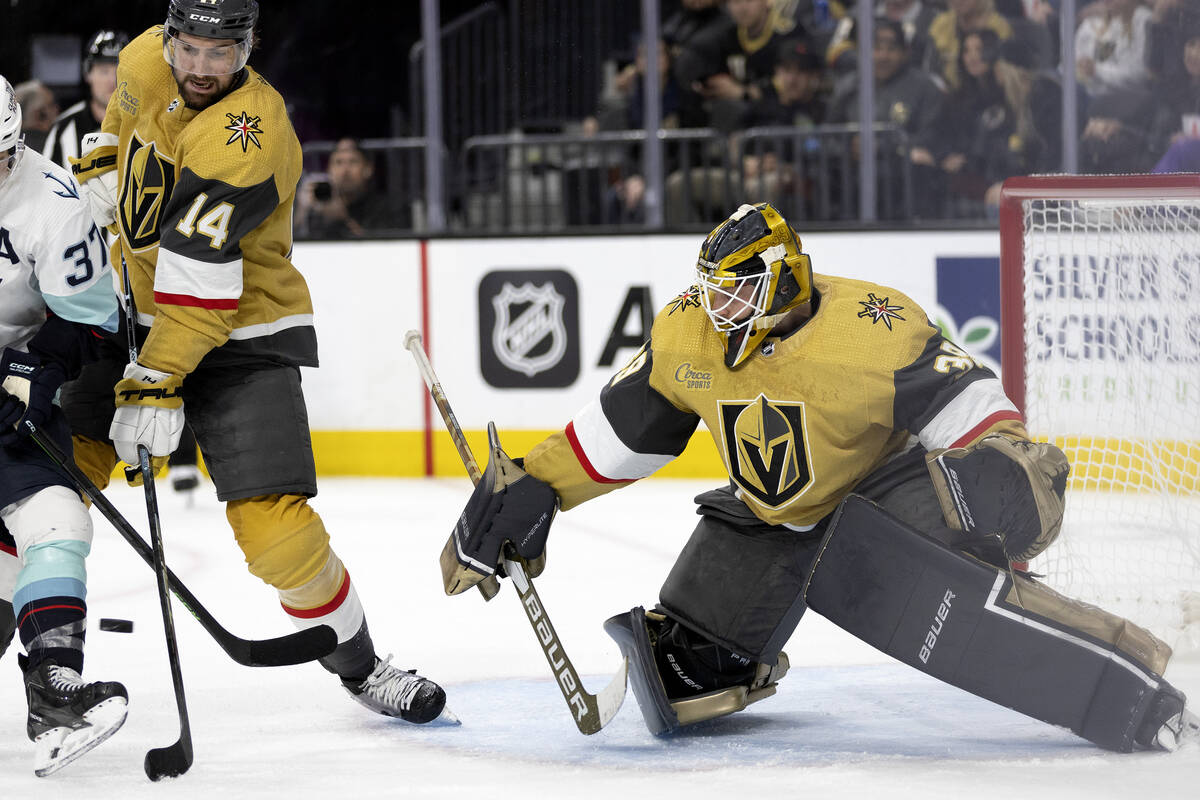 Golden Knights goaltender Laurent Brossoit (39) prepares to save while defenseman Nicolas Hague ...