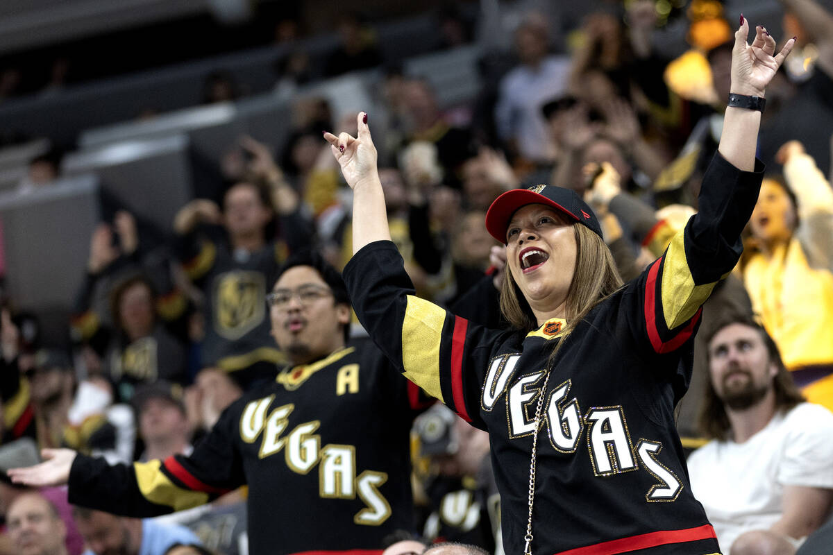 Golden Knights fans cheer during the third period of an NHL hockey game against the Seattle Kra ...