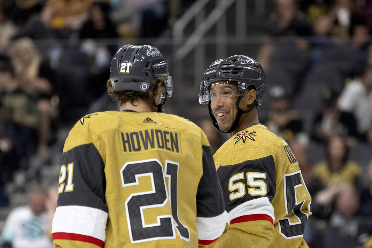 Golden Knights center Brett Howden (21) and right wing Keegan Kolesar (55) chat in between play ...