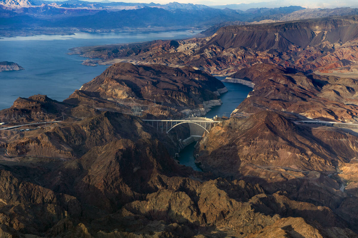 The Hoover Dam with the lower Lake Mead shoreline, above, and Colorado River continuing below o ...