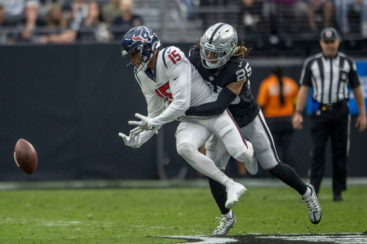 Raiders safety Tre'von Moehrig (25) makes a tackle on Houston Texans wide receiver Chris Moore ...