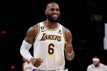 Los Angeles Lakers forward LeBron James smiles after scoring during the second half of an NBA b ...