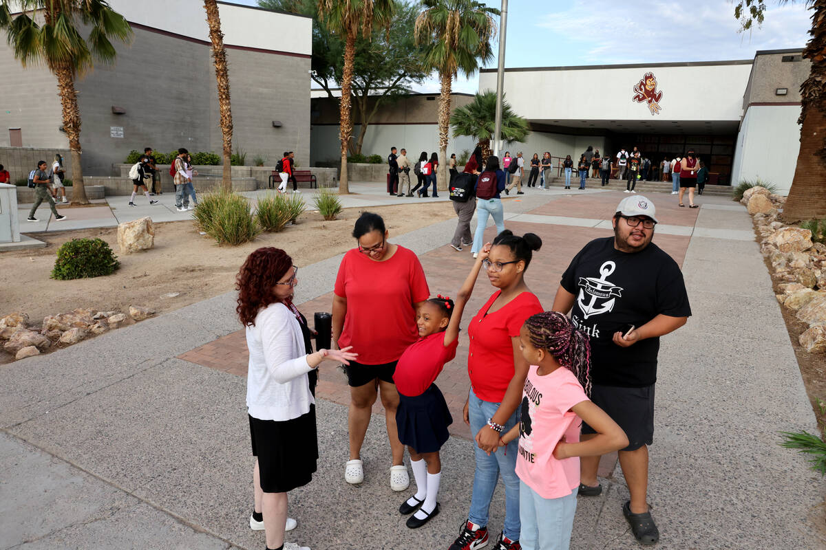 Teacher Jesica Benton talks to a family at Eldorado High School in Las Vegas on Monday, Aug. 8, ...