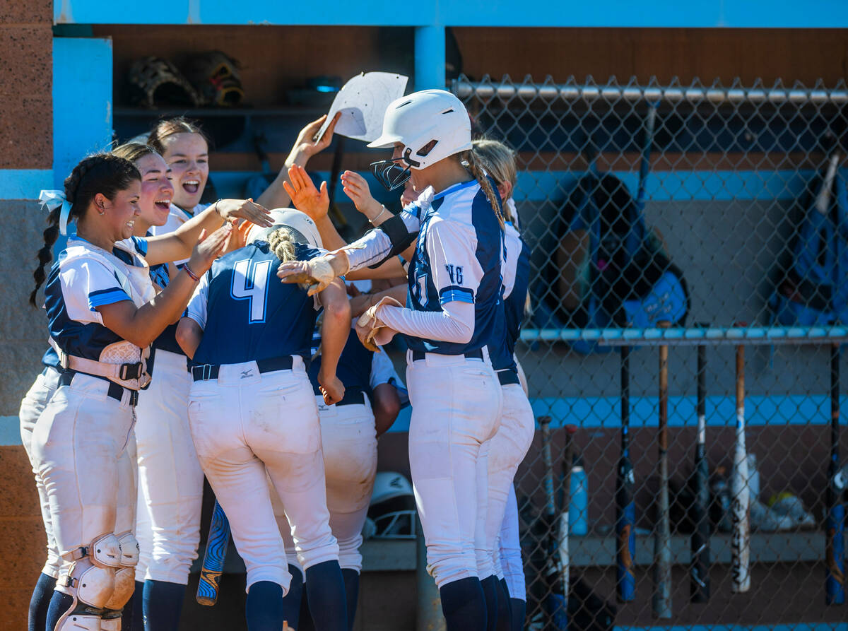 Centennial runner Teagan Clemmons (4) is celebrated for a grand slam with teammates against Lib ...