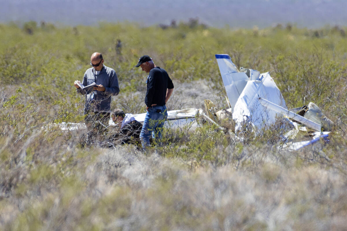 Officials from the FAA investigate a plane crash where two people died, on Tuesday, April 11, 2 ...