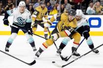 Golden Knights center William Karlsson (71) battles for the puck with Seattle Kraken right wing ...