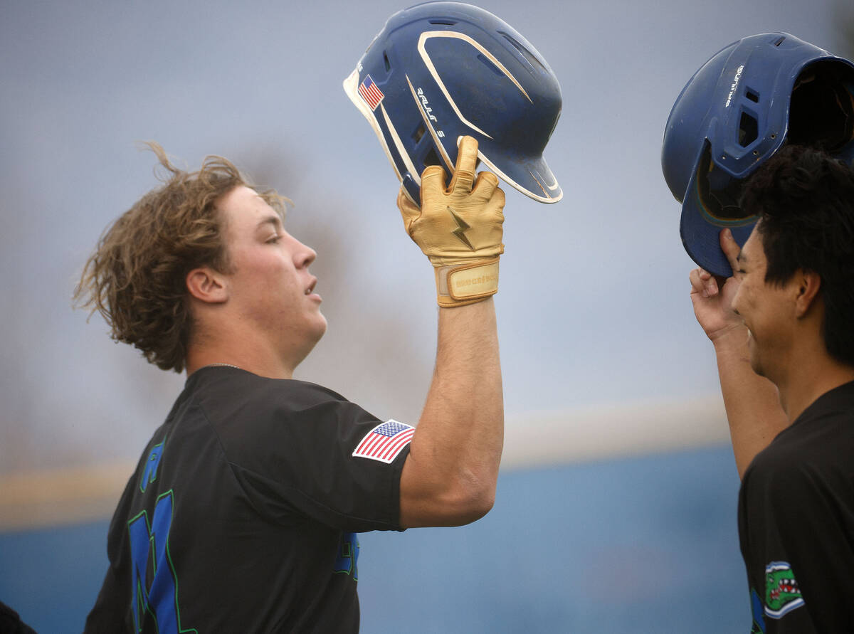 Green Valley's Chaz McNelis (41), left, celebrates with his teammate Tyler Okui (6) after hitti ...