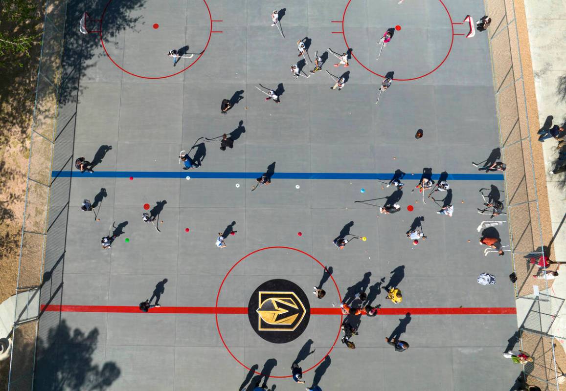 Children play on the Vegas Golden Kight's Ball Hockey Rink at Lorenzi Park after the ribbon cut ...