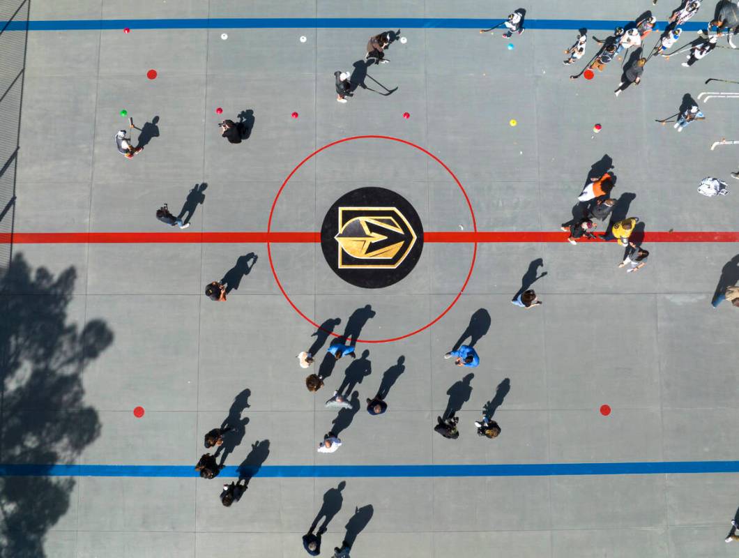 Children play on the Vegas Golden Kight's Ball Hockey Rink at Lorenzi Park after the ribbon cut ...