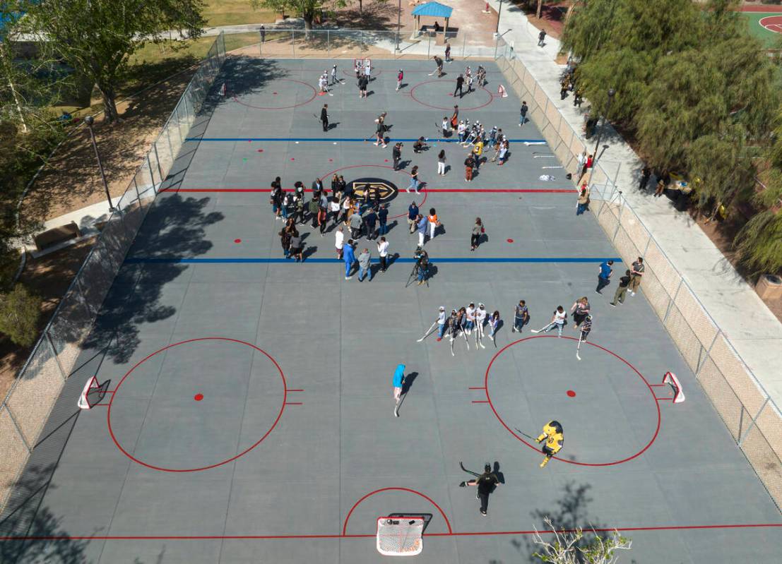 Children play on the Vegas Golden Kight's Ball Hockey Rink at Lorenzi Park after the ribbon cut ...