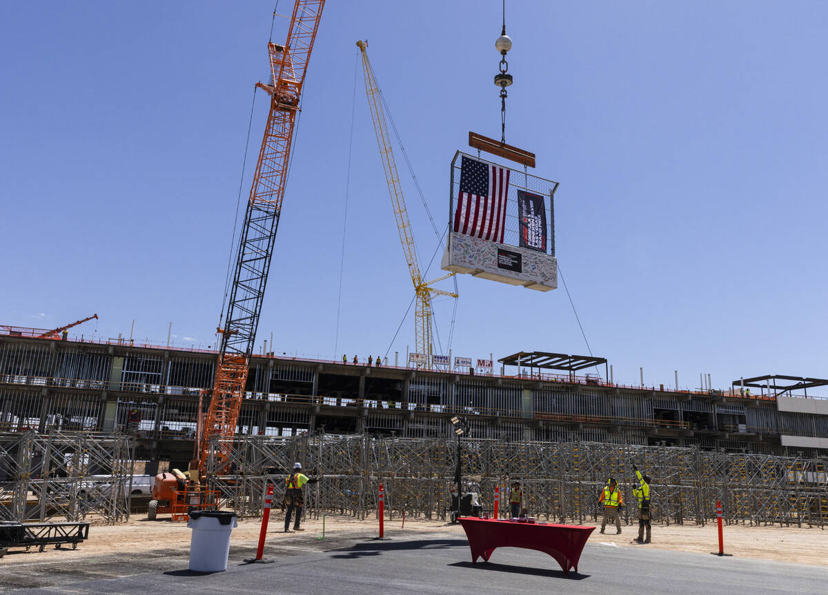 Construction crews hoist a barrier during a topping off ceremony for the Formula One Las Vegas ...