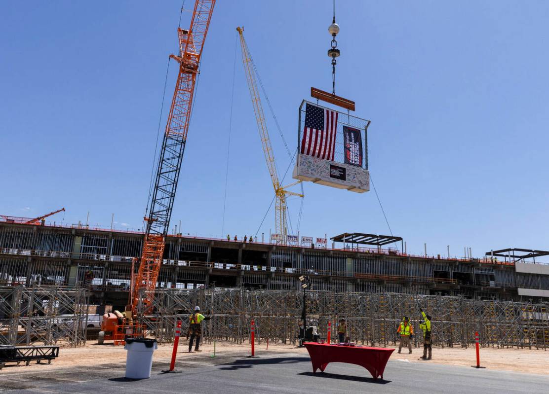 Construction crews hoist a barrier during a topping off ceremony for the Formula One Las Vegas ...