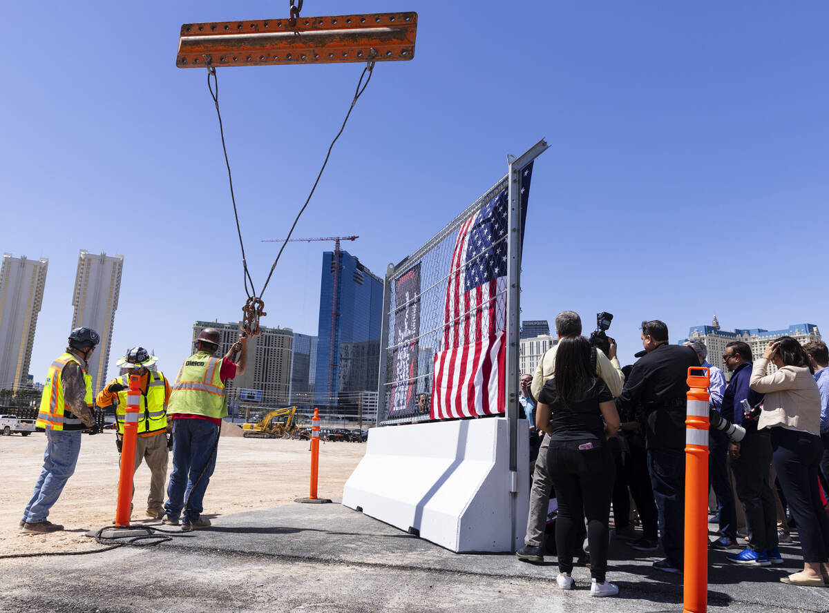 Guests gathered to sign on a barrier during a topping off ceremony for the Formula One Las Vega ...