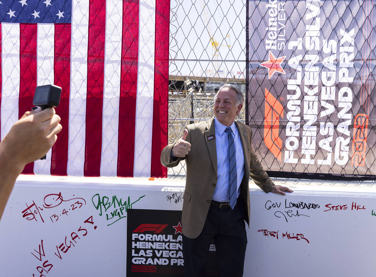 Gov. Joe Lombardo flashes a thumbs up after signing on a barrier during a topping off ceremony ...
