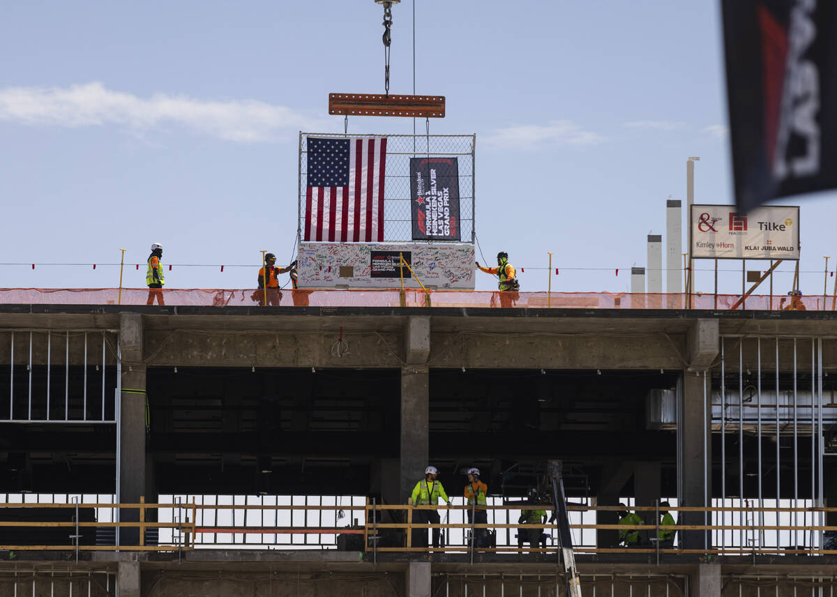 Construction crews hoist a barrier during a topping off ceremony for the Formula One Las Vegas ...