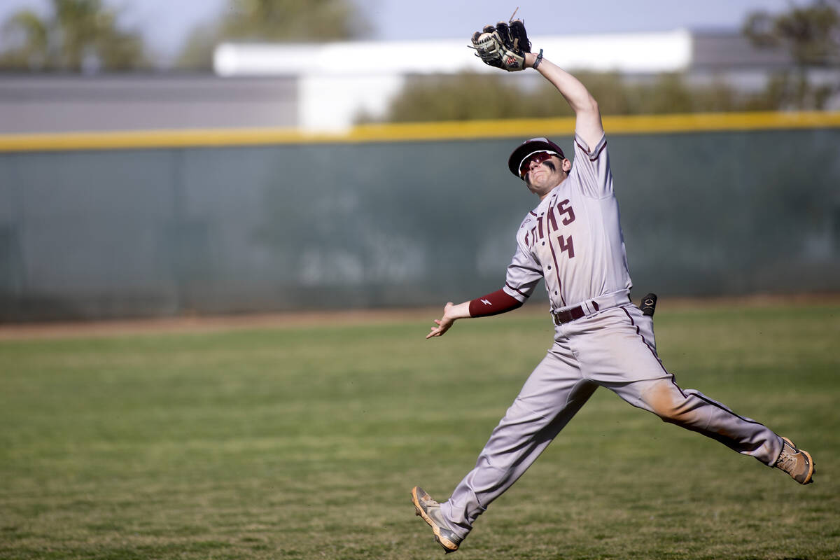 Cimarron-Memorial’s Jaryn McLaughlin jumps to catch for an out during a high school base ...