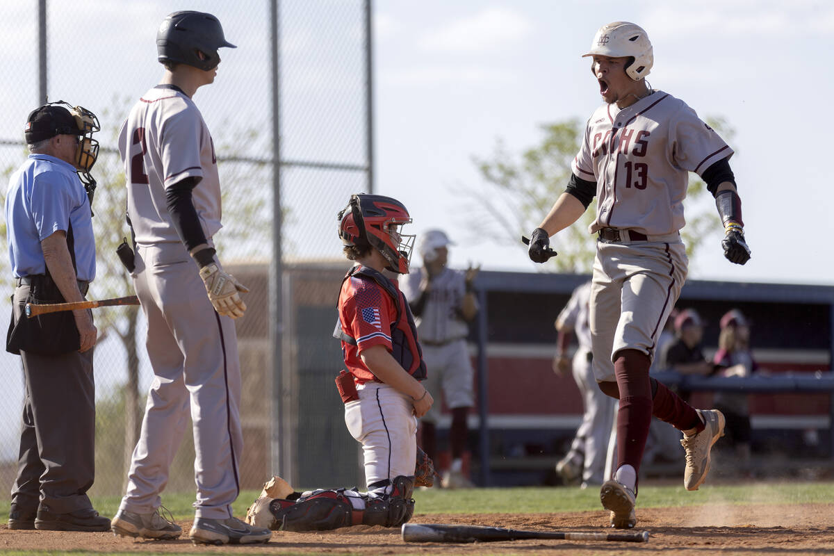 Cimarron-Memorial’s Andrew Overland (13) celebrates as he makes it to home plate after h ...
