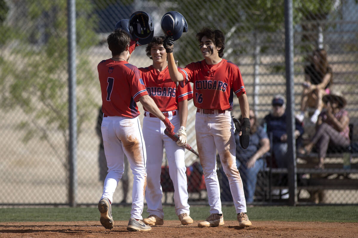 Coronado’s Noah Wong, center, and Nick Morrison (16) congratulate their teammate Evan Fe ...