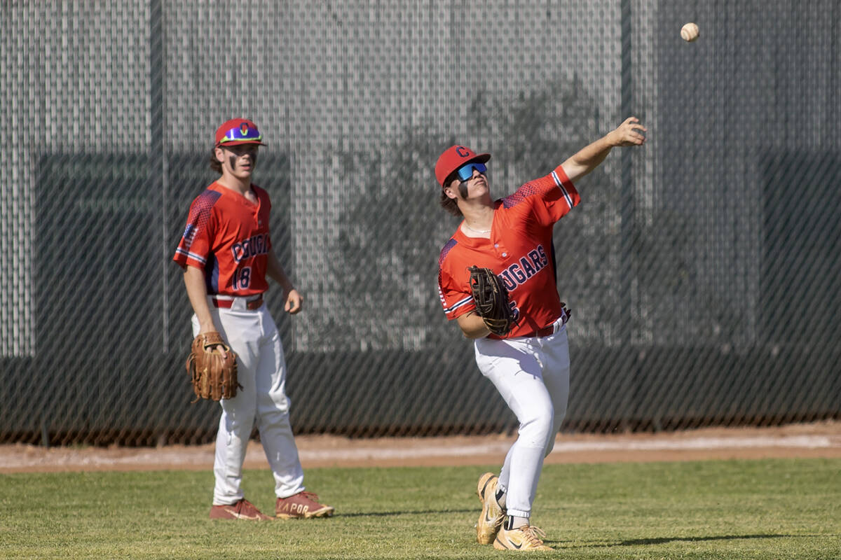 Coronado’s AJ Victoravich (15) throws to the infield while fellow outfielder Ty Phillips (18) ...