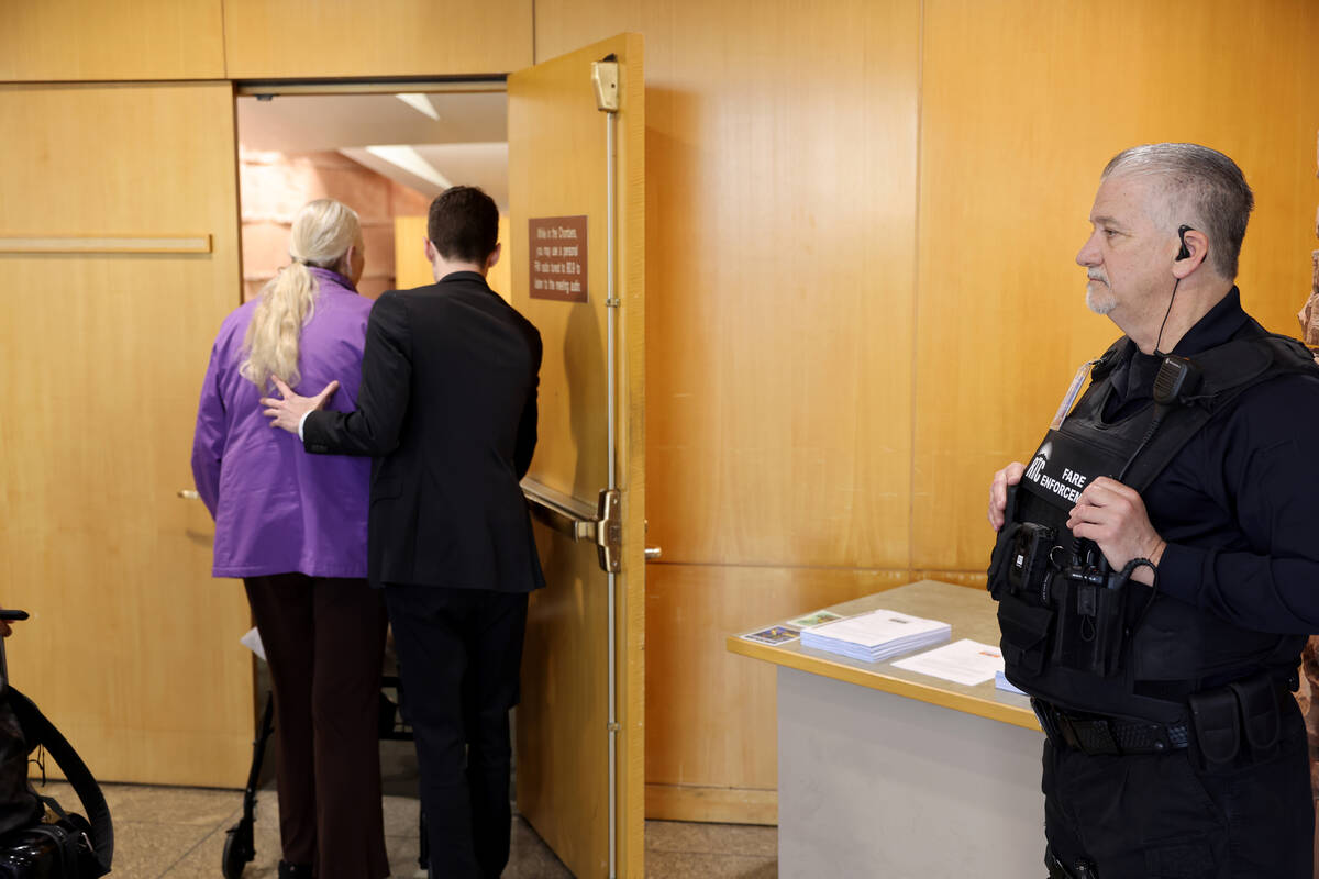A Regional Transportation Commission fare enforcement officer stands guard outside a meeting of ...