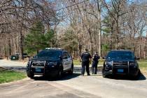 Police block a road in North Dighton, Mass., Thursday, April 13, 2023. The FBI took a 21-year-o ...