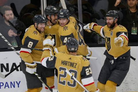 Golden Knights center Ivan Barbashev (49) celebrates with his teammates after scoring against L ...