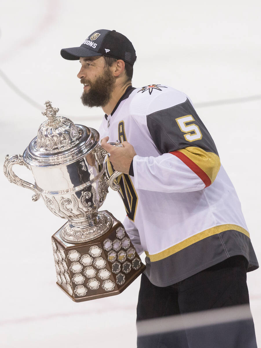 Golden Knights defenseman Deryk Engelland (5) holds the Clarence Campbell Bowl trophy after Las ...