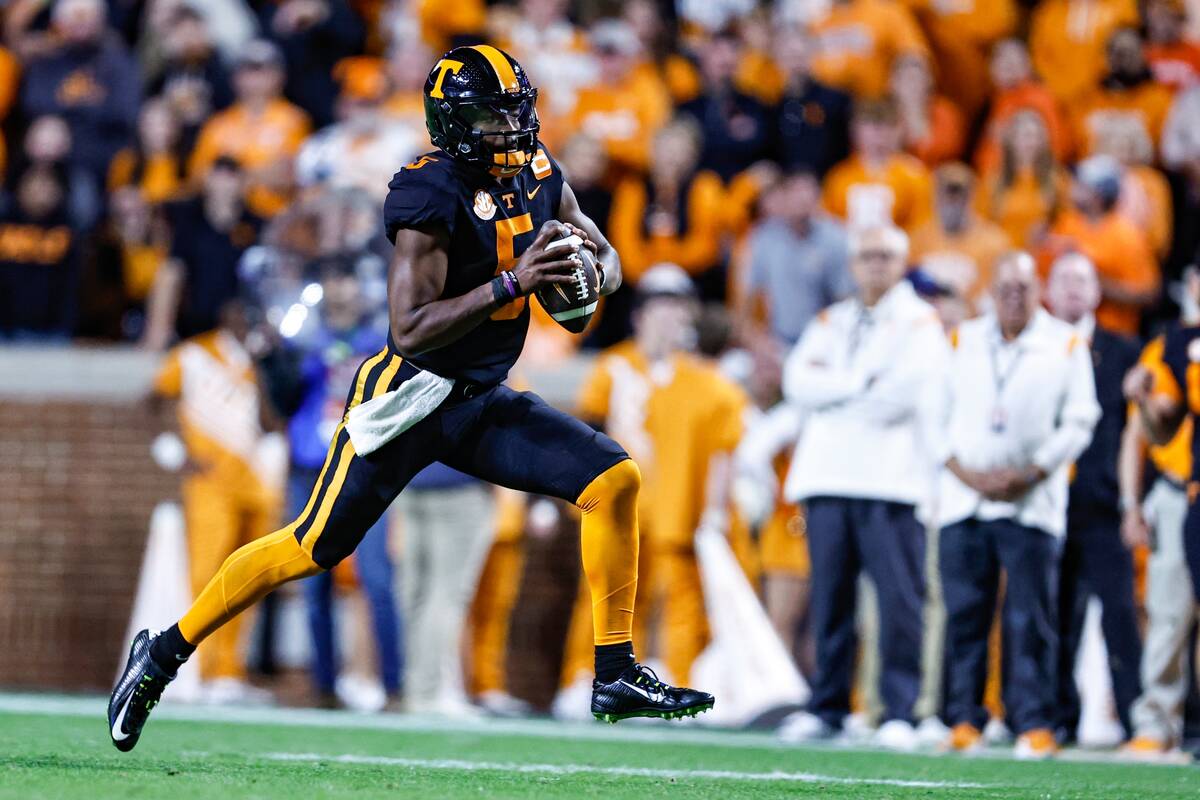 Tennessee quarterback Hendon Hooker (5) runs for yardage during the first half of an NCAA colle ...