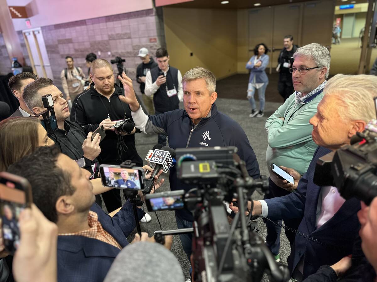 Denver Broncos head coach Sean Payton is interviewed by a throng of media in radio row during S ...