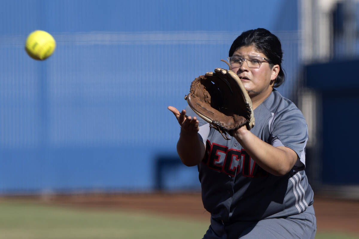 Tech’s Ivet Flores-Cruz reaches to catch for an out at first base during a high school s ...
