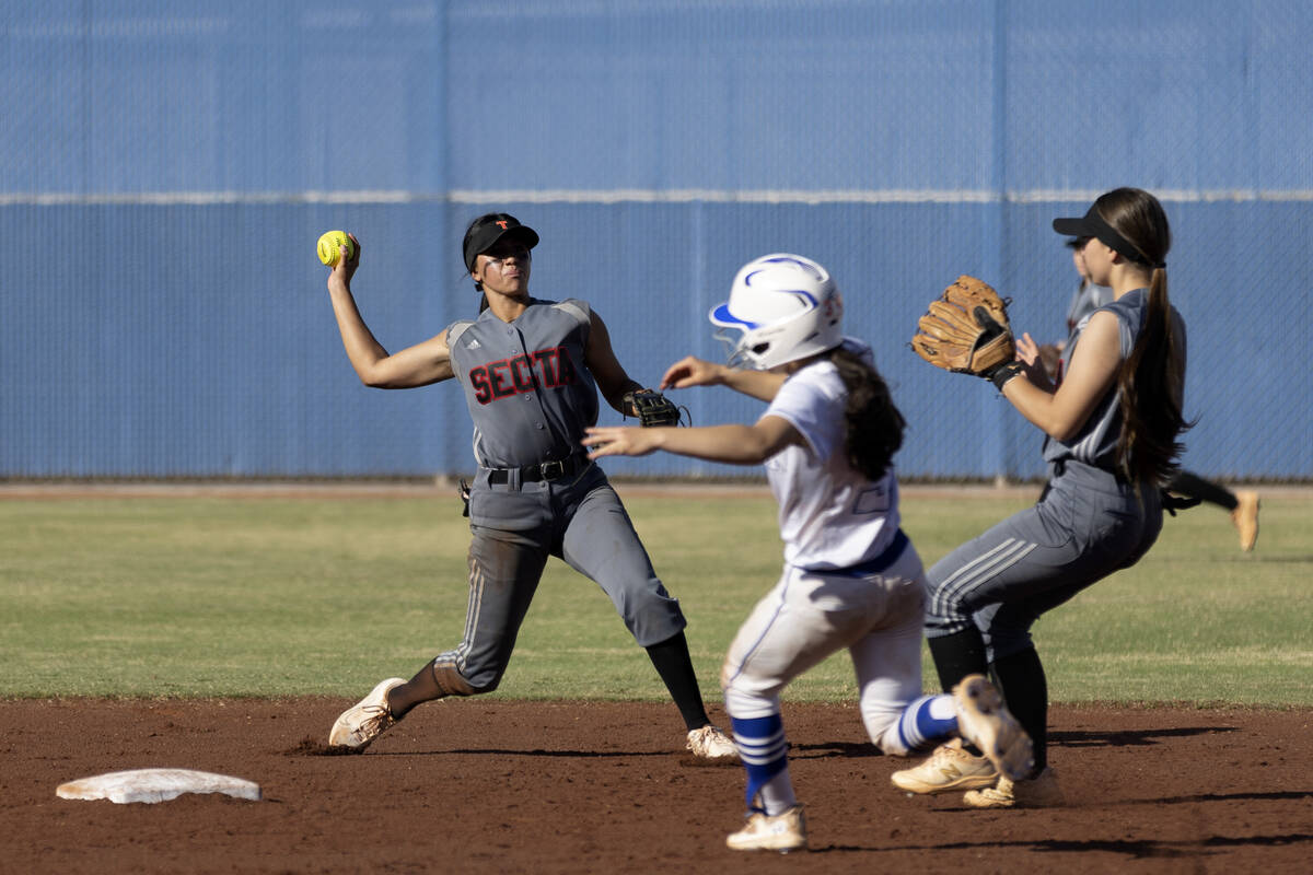 Tech second baseman Presley Benavidez, left, favors first base for an out while Bishop Gorman&# ...