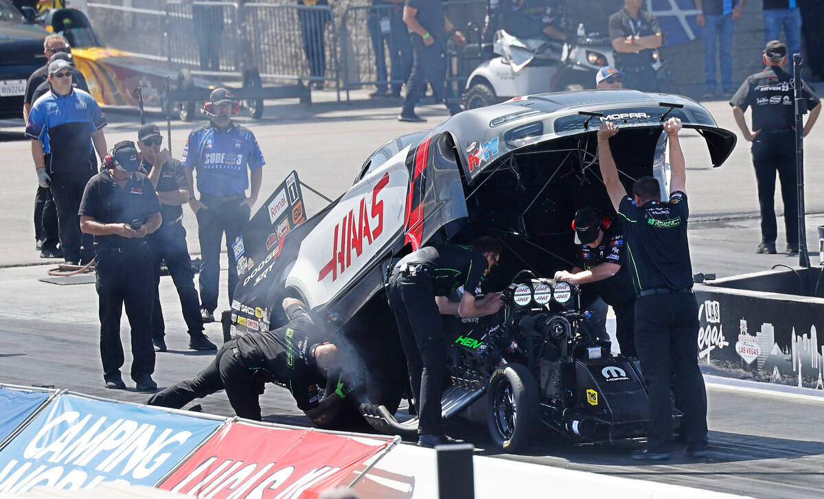 NHRA driver Matt Hagan’s team members check his funny car before the first Nitro qualify ...