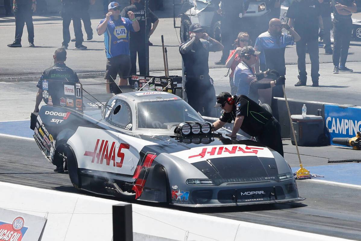 NHRA driver Matt Hagan’s team members check his funny car before the first Nitro qualify ...