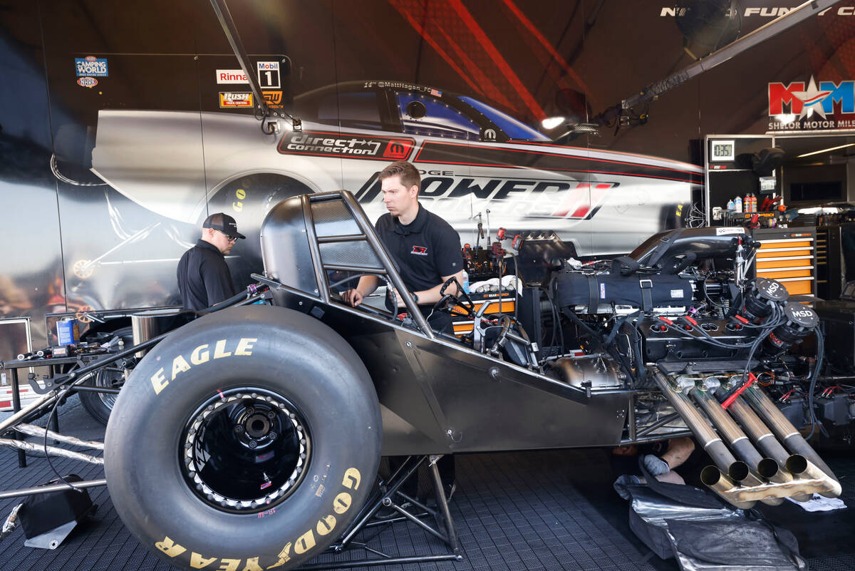 NHRA driver Matt Hagan’s team members check his funny car before the first Nitro qualify ...