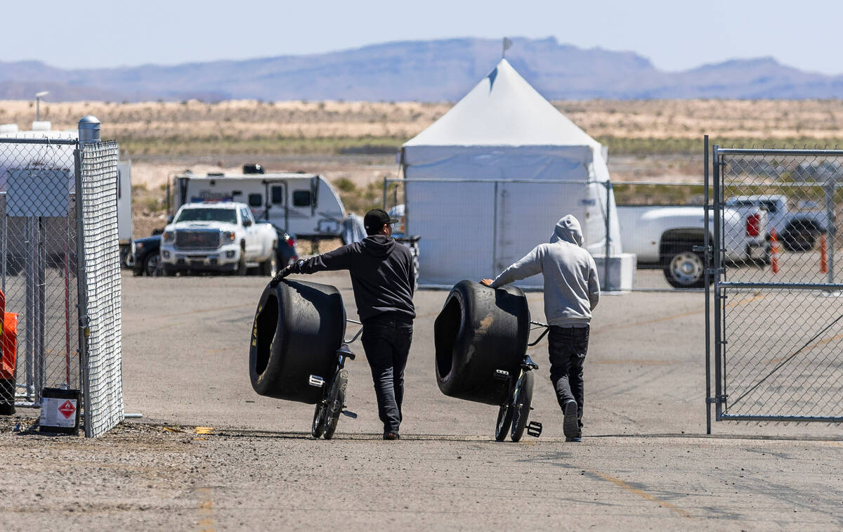 Used racing tires are wheeled off the track during Day 2 of NHRA Nationals at the Las Vegas Mot ...