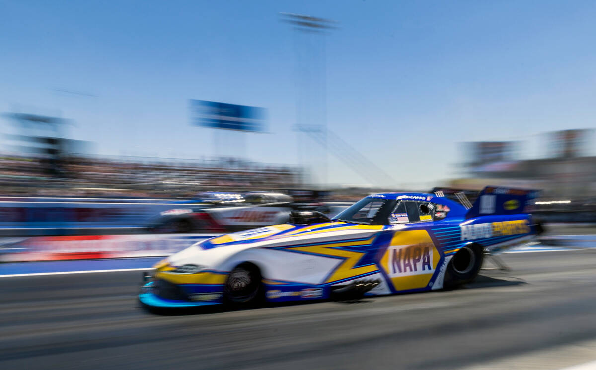 Funny Car driver Ron Capps streams by in a qualifying race during Day 2 of NHRA Nationals at th ...